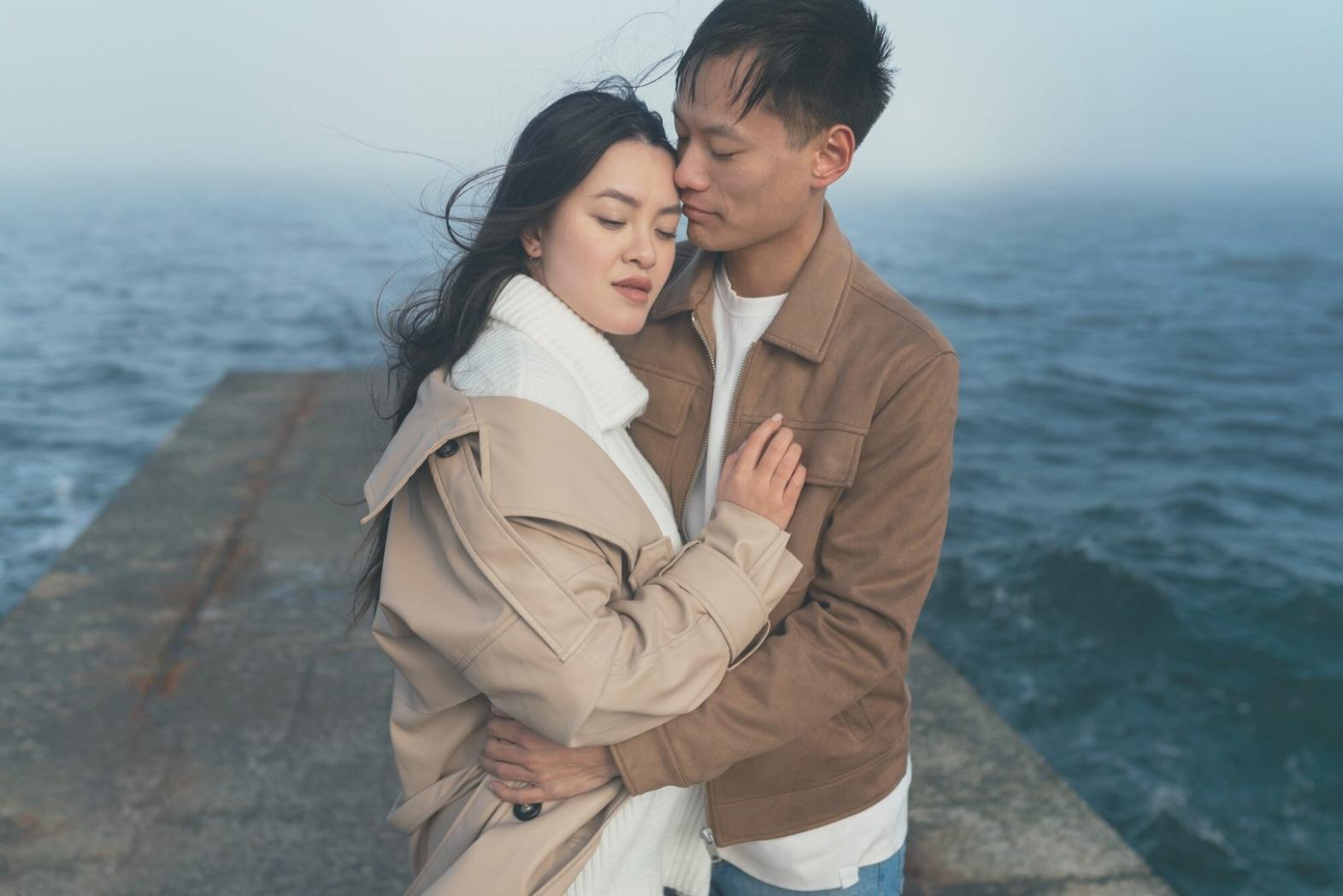 Professional assisting elderly client with meal preparation in home kitchen